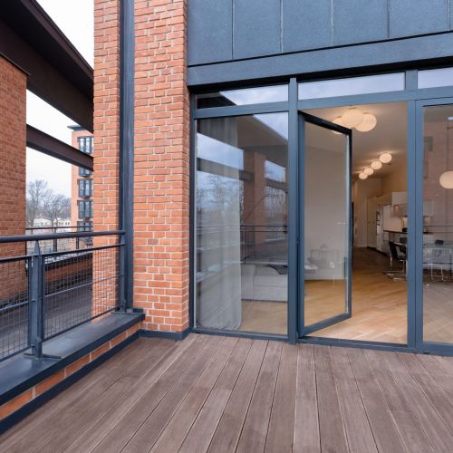 Big,Balcony,With,Wooden,Floor,And,Brick,Walls,And,Modern